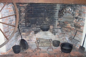 A long-handled frying pan (second from right) and a few pots were all that were necessary for a skilled cook to quickly prepare a hearty meal for a stagecoach load of passengers during the 1830s in northern Illinois.