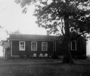My grandparents farmhouse as it looked about 1955, with Grandpa and Grandma Holzhueter's lawn chairs out front. The dining room was at the far left of their house.