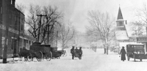 When this photo was snapped looking east on Washington Street in downtown Oswego about 1914, autos had begun sharing snowy winter roads with farmers' wagons and bobsleds.