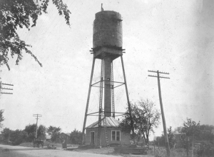 The new steel water tank atop Oswego's 1895 cast iron tower is nearing completion in this 1906 photo. Officials were aghast at what they found floating in the water of the old basswood tank when it was finally uncovered. (Little White School Museum collection)
