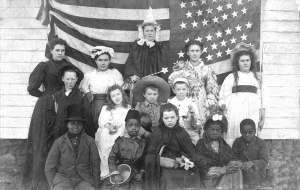 The student body of the Grove School, a one-room country school that served the neighborhood where many of Kendall County's black farming families lived. The Lucas kids, children of Edmund Lucas who married Nathan Hughes' daughter, are in the front row of this 1894 photo apparently taken on a dress-up day.  (Little White School Museum collection)