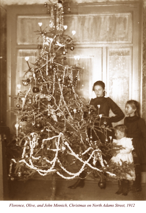 Florence (1902-1924), Olive (1906-1971), and John (1910-1977) Minnich, probably at Christmas 1912. Note John is wearing a dress, common for young male children before World War I. The photo was likely taken at the home of their aunt, Annie Minnich Haines, at North Adams and Second Street, Oswego. Florence died of tuberculosis. Photo probably taken by irvin Haines. Part of the Homer Durand Oswegorama Photo Collection.